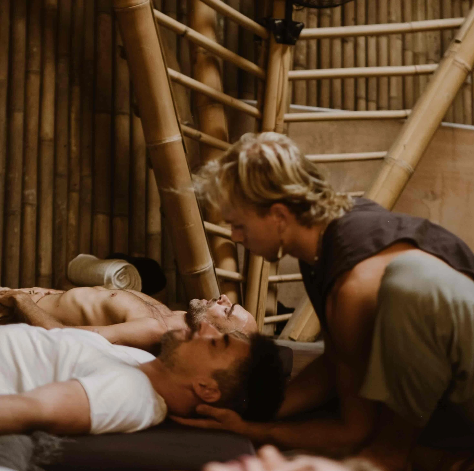 Group breathwork session in a warm bamboo pavilion