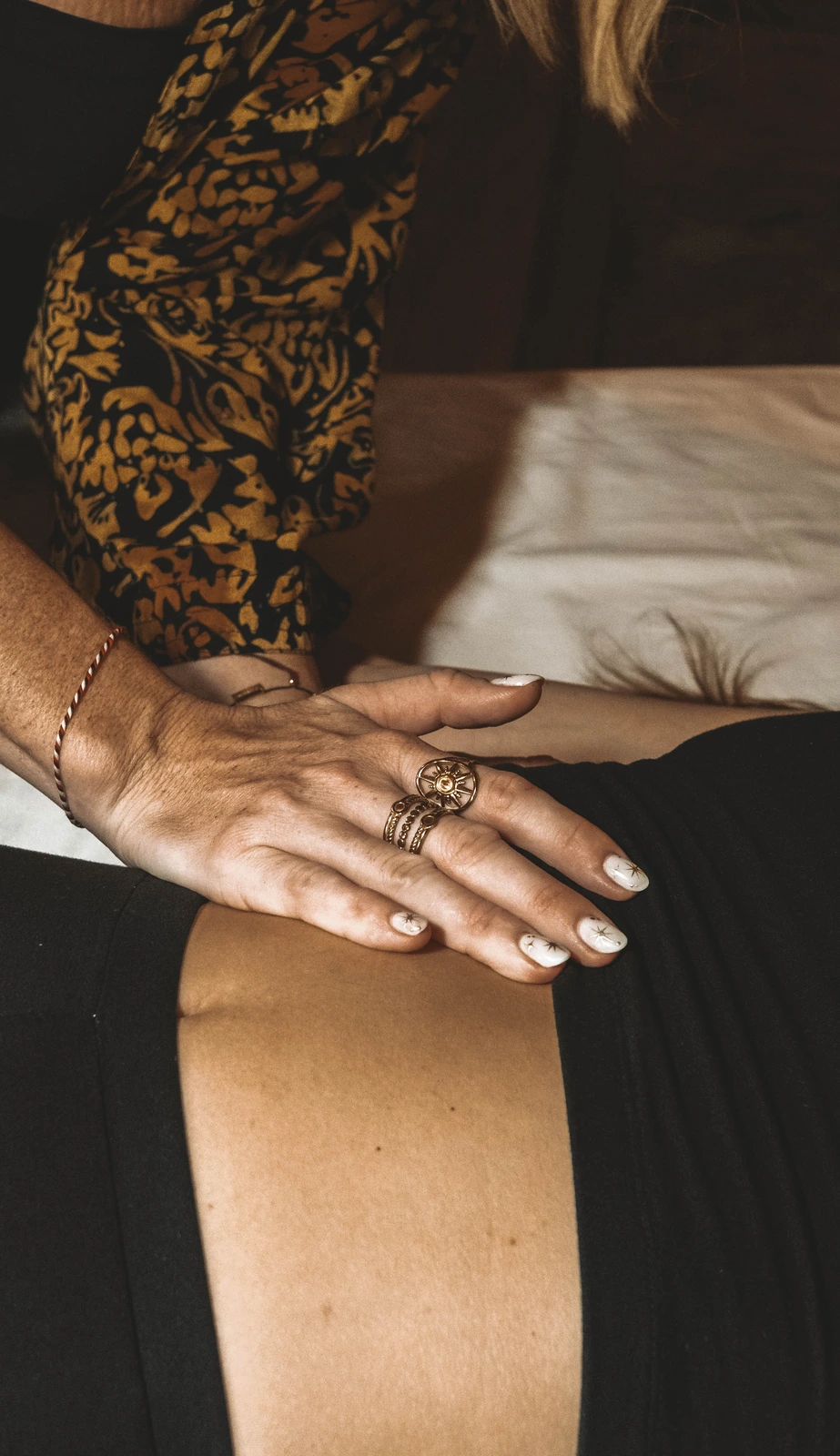 A facilitator's hand resting gently on a client's diaphragm